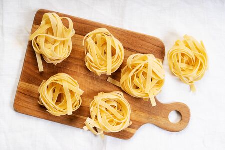 Fettuccine italian pasta on wooden boardの写真素材