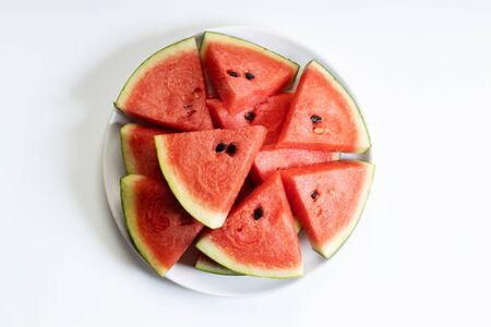 Fresh watermelon slices in white plate on white backgroundの写真素材