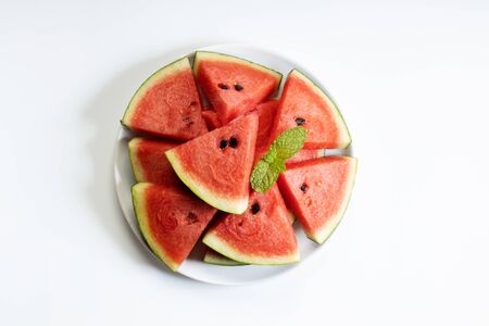 Fresh watermelon slices in white plate on white backgroundの写真素材