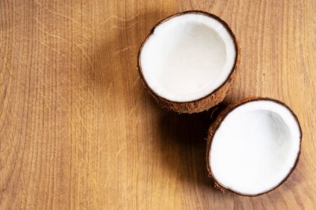 Coconut with hard shell on wooden background, top viewの写真素材