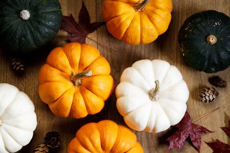 Autumn  with orange pumpkins and  maple leaves on wooden