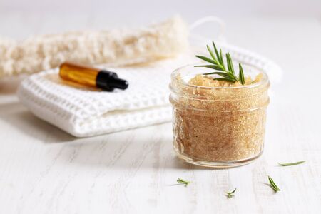 Brown sugar scrubs with herbs and gourd sponge, natural wellness, on white woodenの写真素材