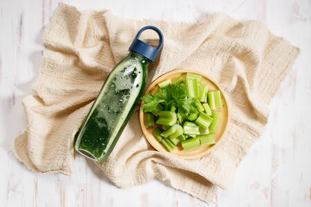 Fresh sliced celery stalk with leaves and celery healthy green juice, top viewの写真素材