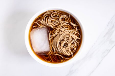 soba noodles, zaru soba, in white bowl with bamboo chopsticksの写真素材