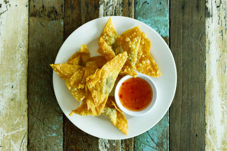 Fried dumpling and spicy sauce on wood table, top view.の写真素材