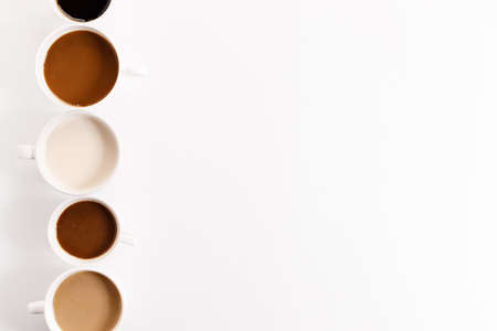 cups of coffee on white background with color gradient of coffee by varing amount of milk,top viewの写真素材