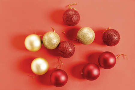 Chirstmas holiday festive baubles with red and golden color closeup on red backgroundの写真素材