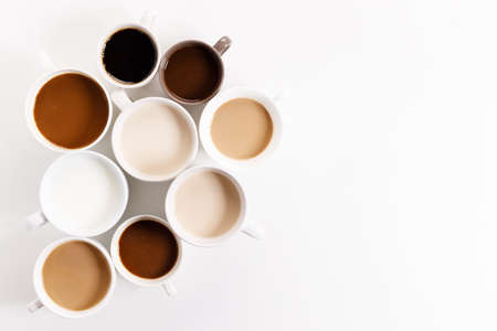 cups of coffee on white background with color gradient of coffee by varing amount of milk,top viewの写真素材