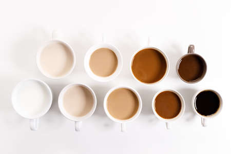 cups of coffee on white background with color gradient of coffee by varing amount of milk,top viewの写真素材