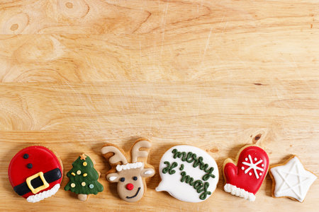 Christmas cookies in various shape with Christmas theme on wooden board, top view with copy spaceの写真素材