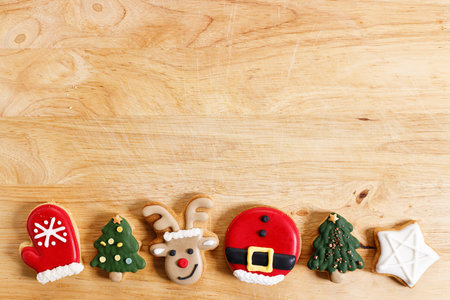 Christmas cookies in various shape with Christmas theme on wooden board, top view with copy spaceの写真素材