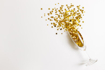 Christmas or new year background with glass of golden glitters, abstract celebration concept. flat lat arrangement with copy space.の写真素材