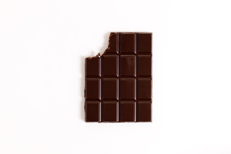 Chocolate bar with teeth bite on white background, top view.の写真素材