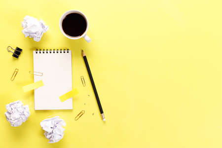 Top view of messy office table top with many blank sticky notes and equipment.の写真素材