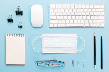 Top view of office working desktop. on blue color background.の写真素材