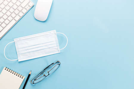 Top view of office working desktop. On blue color background.の写真素材