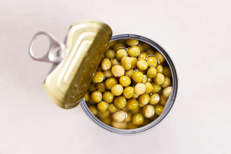 Open tin can of green bean on kitchen table background. top view.の写真素材