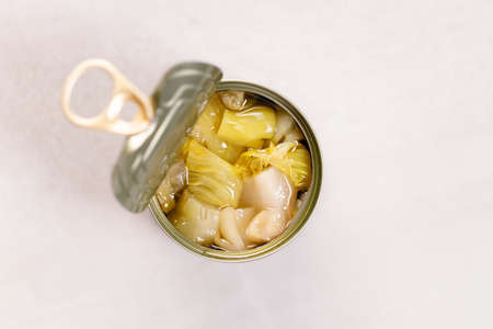 Open tin can of vegetable on kitchen table background. top view.の写真素材