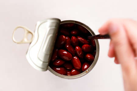 Open tin can of red bean on kitchen table background. top view.の写真素材