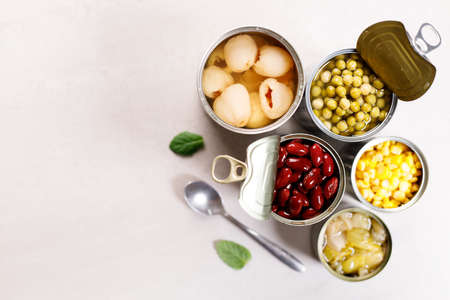Different kinds of vegetables in cans on kitchen table background.の写真素材
