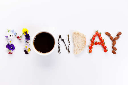 Word "MONDAY" made of flowers, coffee and edible things on white background. Spring concept. Top view.の写真素材