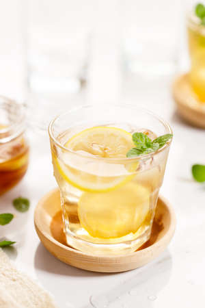 Lemonade with Iced Tea and peppermint on white table. Summer refreshments.の写真素材