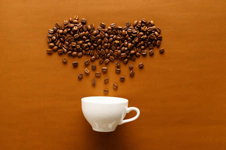 roasted coffee beans on a brown paper background with abstract shape, topview.の写真素材