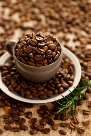 coffee beans roasted in a coffee cup on coffee beans background, closeupの写真素材