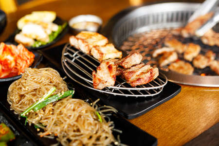 Korean style pork barbecue with vegetable side dishの写真素材