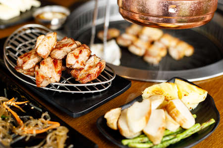 Korean style pork barbecue with vegetable side dishの写真素材