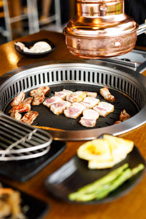 Korean style pork barbecue with vegetable side dishの写真素材