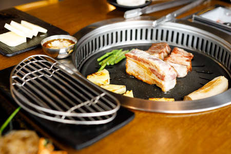 Korean style pork barbecue with vegetable side dishの写真素材