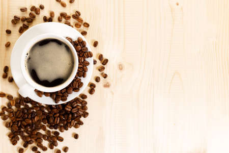 Cup of black coffee with coffee beansの写真素材