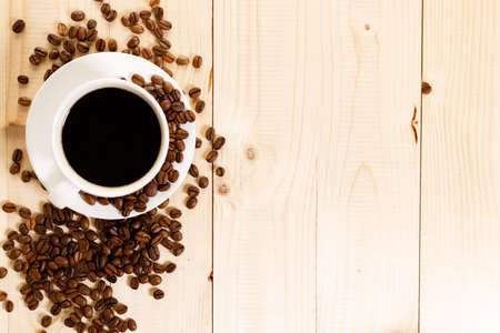 Cup of black coffee with coffee beansの写真素材