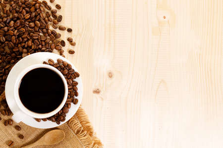 Cup of black coffee with coffee beansの写真素材
