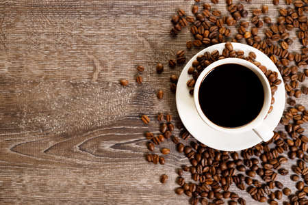 Cup of black coffee with coffee beansの写真素材