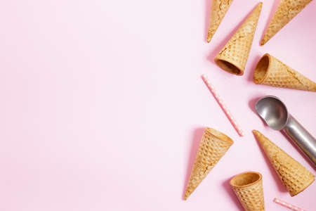 Empty ice cream cones on pink background. Sweet and summer concept. Top view.の写真素材