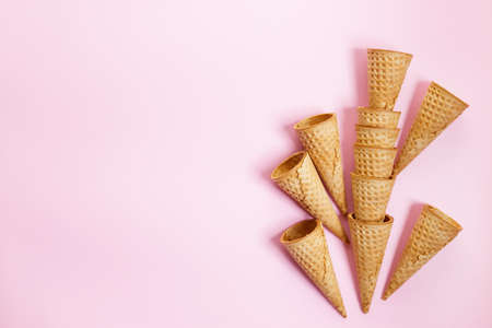 Empty ice cream cones on pink background. Sweet and summer concept. Top view.の写真素材