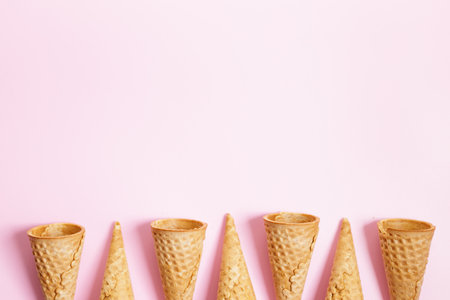 Empty ice cream cones on pink background. Sweet and summer concept. Top view.の写真素材