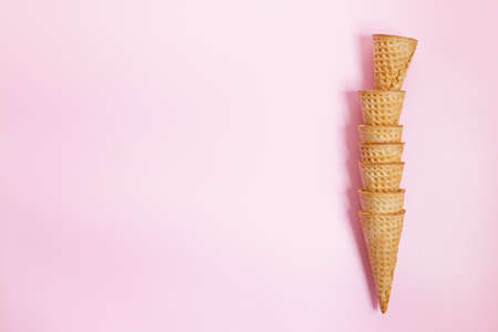 Empty ice cream cones on pink background. Sweet and summer concept. Top view.の写真素材