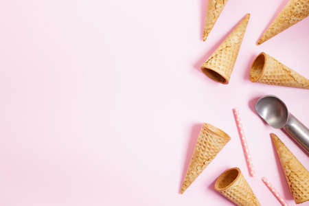 Empty ice cream cones on pink background. Sweet and summer concept. Top view.の写真素材