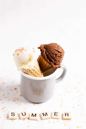 Waffle ice cream cones on with ice cream on white wooden background. Sweet and summer concept.の写真素材