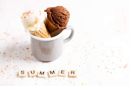 Waffle ice cream cones on with ice cream on white wooden background. Sweet and summer concept.の写真素材