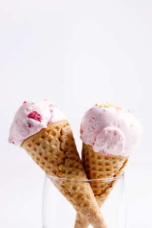 sweet ice cream made of strawberry in cones on white backgroundの写真素材