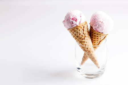 sweet ice cream made of strawberry in cones on white backgroundの写真素材