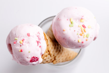 sweet ice cream made of strawberry in cones on white backgroundの写真素材