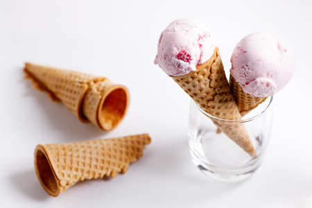 sweet ice cream made of strawberry in cones on white backgroundの写真素材