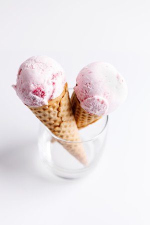 sweet ice cream made of strawberry in cones on white backgroundの写真素材