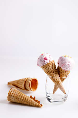 sweet ice cream made of strawberry in cones on white backgroundの写真素材