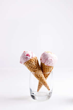 sweet ice cream made of strawberry in cones on white backgroundの写真素材